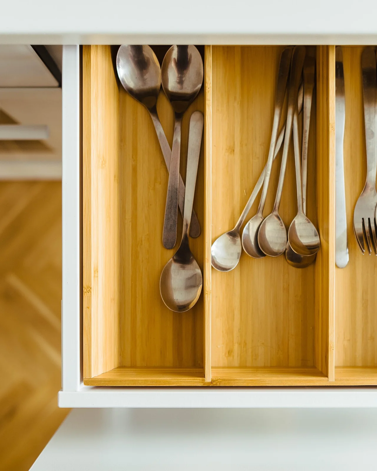 A fitted kitchen drawer with wooden utensil dividers