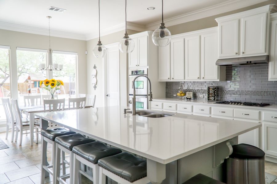 Bright remodeled kitchen with white cabinets and large island
